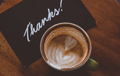 Cup of coffee with a "thank you" note