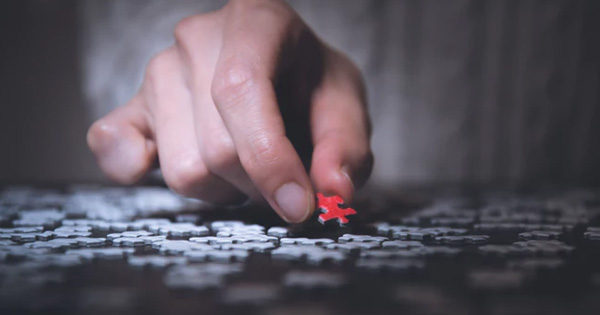 Man placing puzzle piece